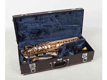 A Yamaha brass alto saxophone in hard ca