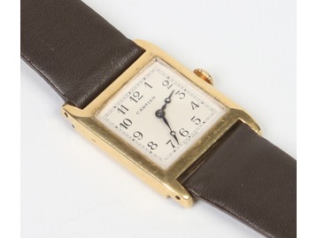 A Cartier gold cased manual wristwatch.