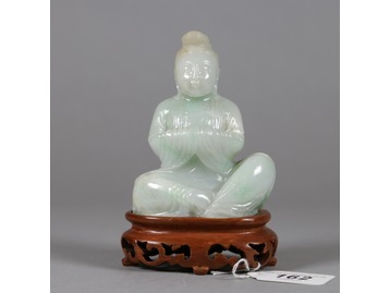 A Chinese pale jade figure.