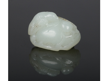 A Chinese carved pale celadon jade carvi
