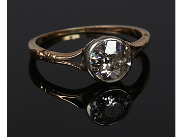 An 18 carat gold solitaire diamond ring.