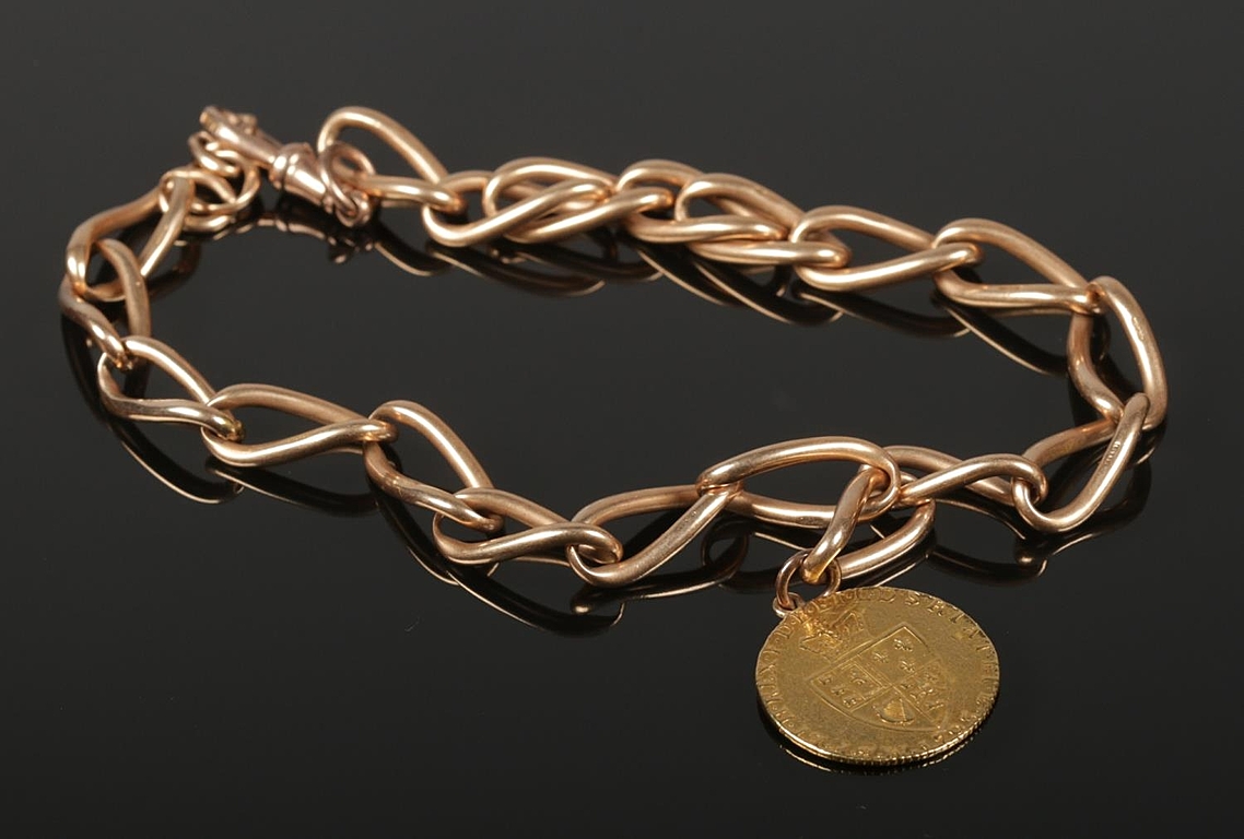 A 1793 spade guinea on 15ct gold chain a
