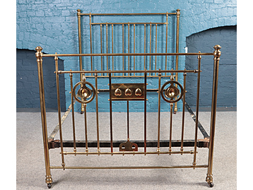 A Victorian brass bed frame with Arts & 