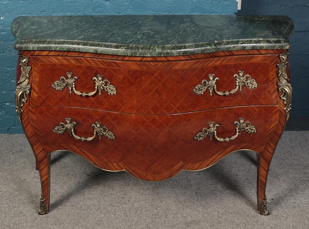 A bombe shaped commode with green marble