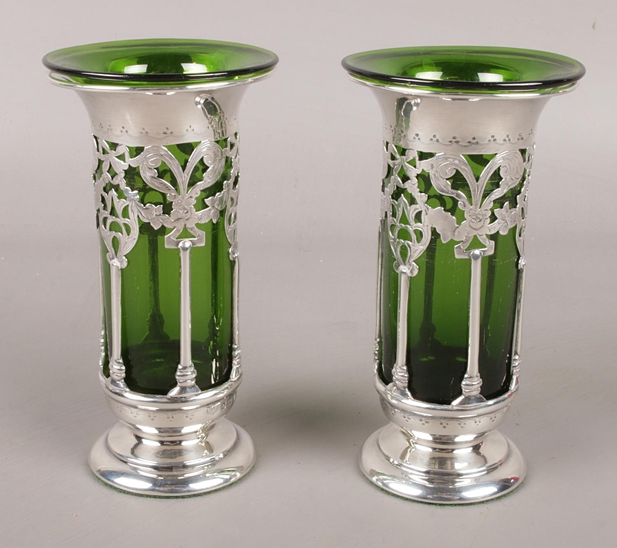 A pair of weighted pierced silver vases 