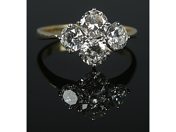 An 18ct gold and four stone diamond ring