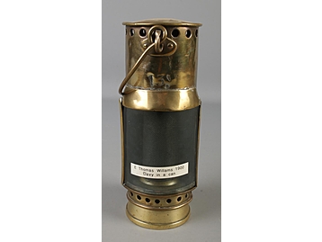 A brass miners lamp with outer brass cas