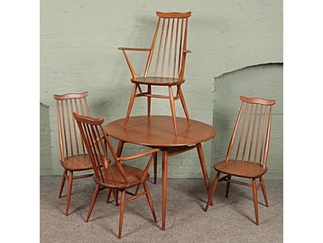 An Ercol circular dining table and four 