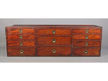 A mahogany fronted bank of ten drawers, 
