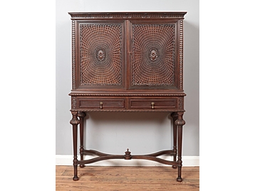 A Liberty & Co carved mahogany cabinet. 