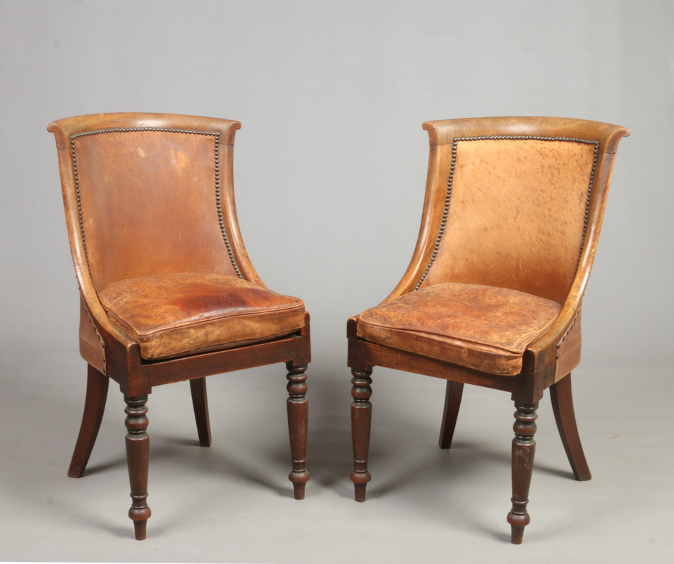 A pair of Regency mahogany leather uphol